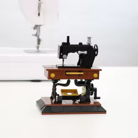 Model of a sewing machine on a white background