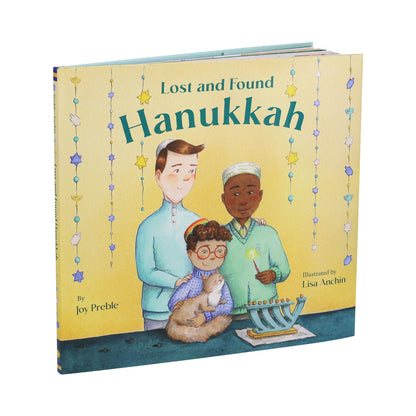 Book titled 'Lost and Found Hanukkah' with illustrations of three children and a menorah on a yellow background.