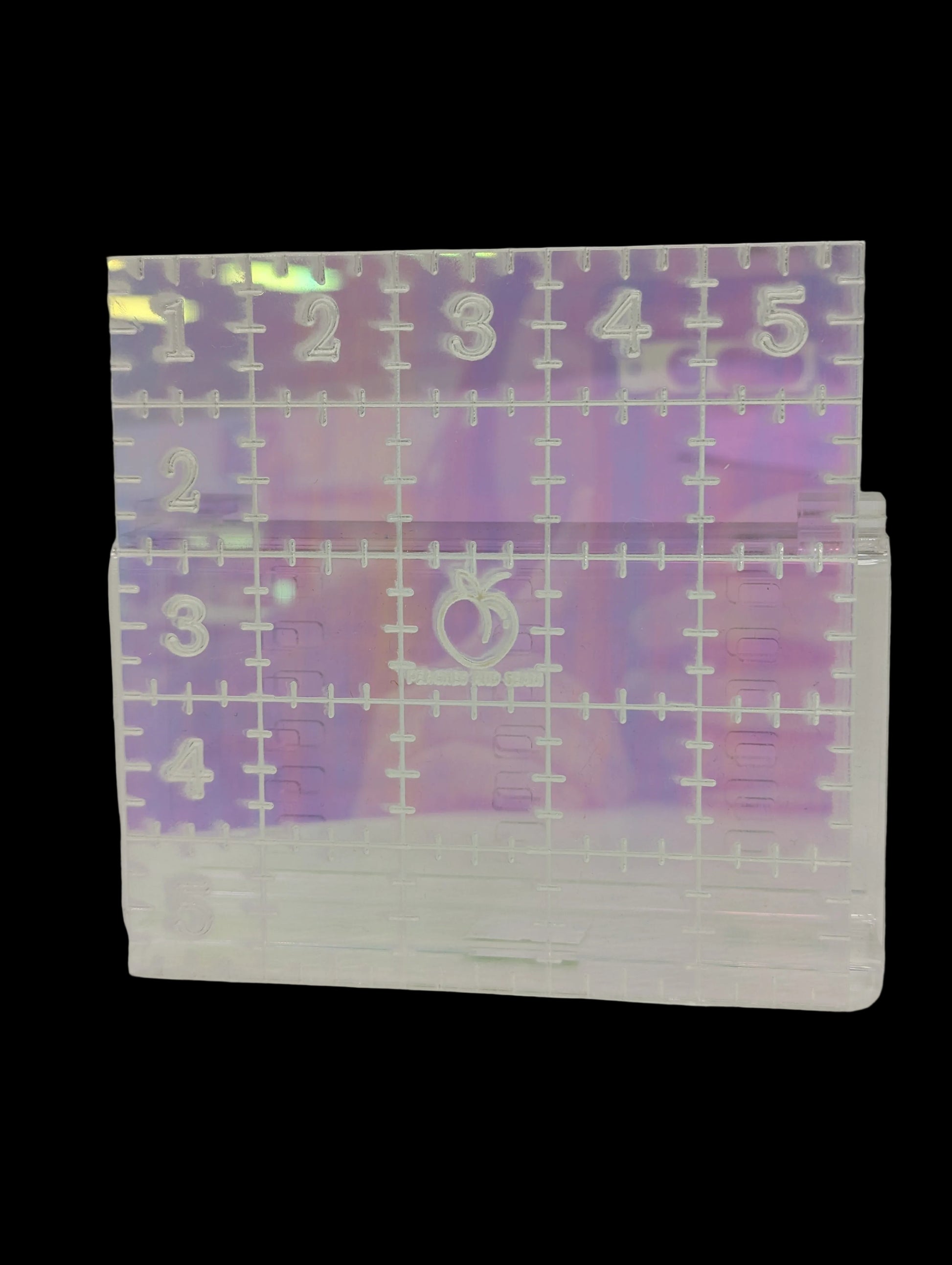 Transparent ruler with numbers and symbols on a white surface