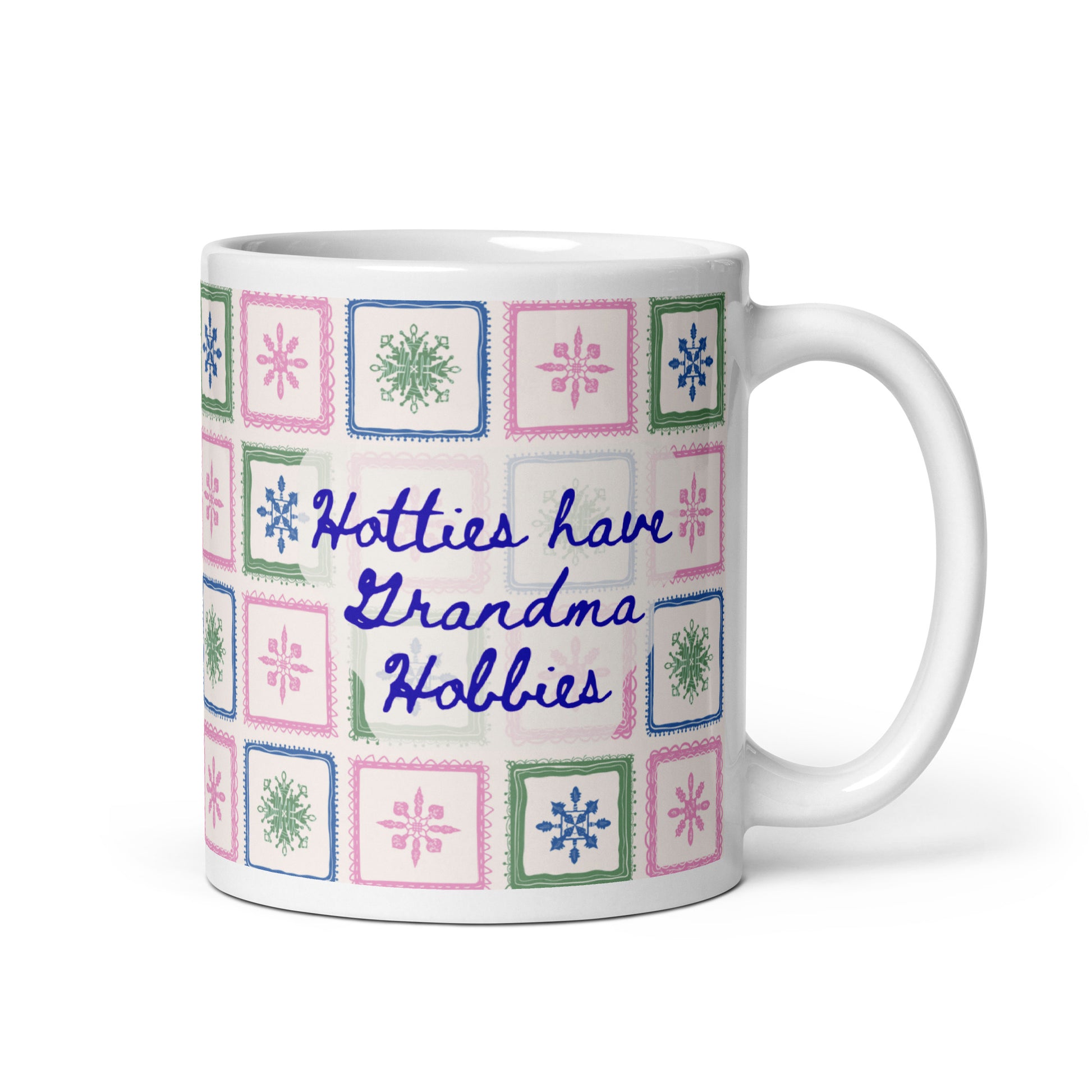 Mug with colorful quilt pattern and text "Hotties have Grandma Hobbies" on a white background